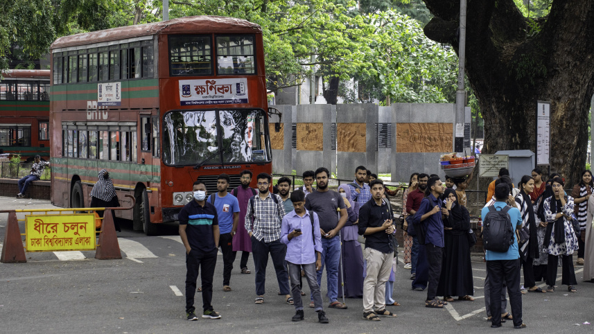 Group of students waiting at the bus stop in the Dhaka University campus.