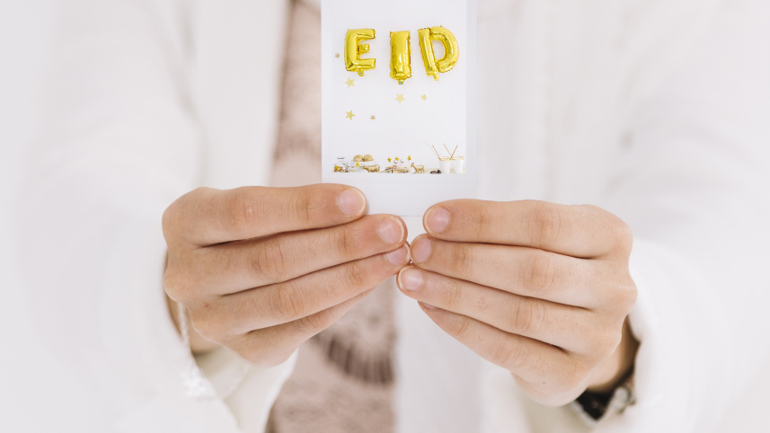 eid-al-fitr-concept-with-hands-showing-card.jpg