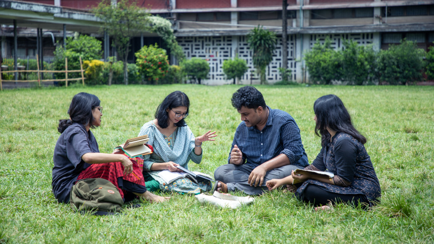 Four friends discussing things on campus