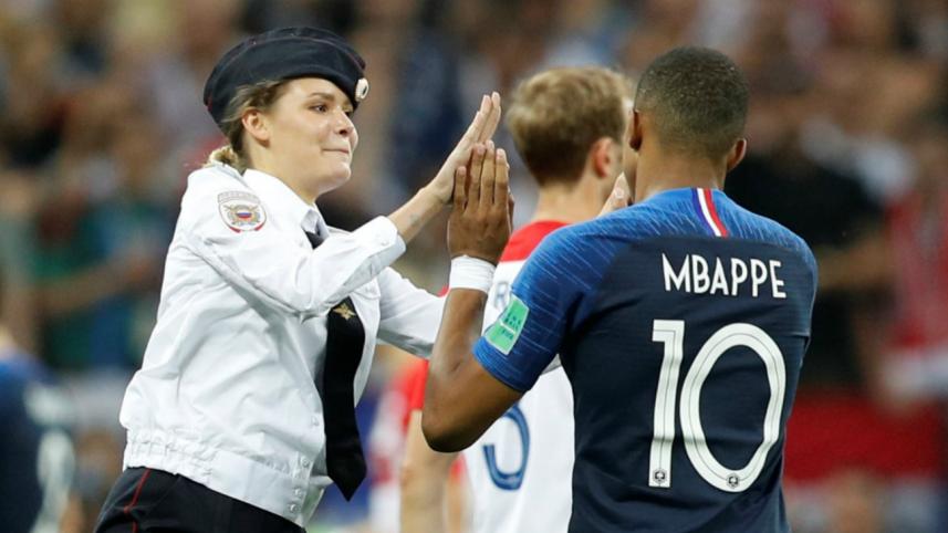 Pitch invader and France's Kylian Mbappe