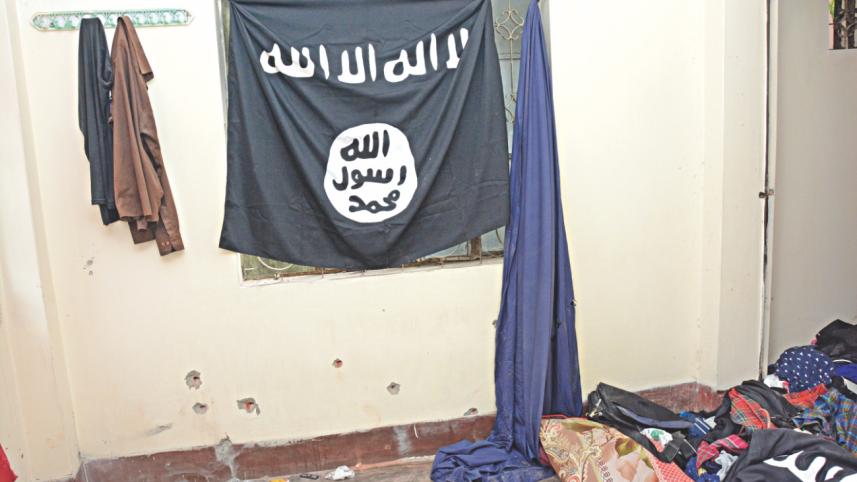  black cloth inscribed with Arabic words at the “militant den” in the city's Kalyanpur. The cloth resembles the flags seen with IS militants in photos run by media. Photo: DMP