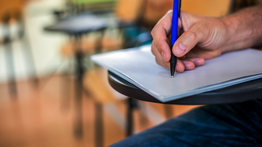 man-is-writing-signing-paper-focused-hand-with-pen.png