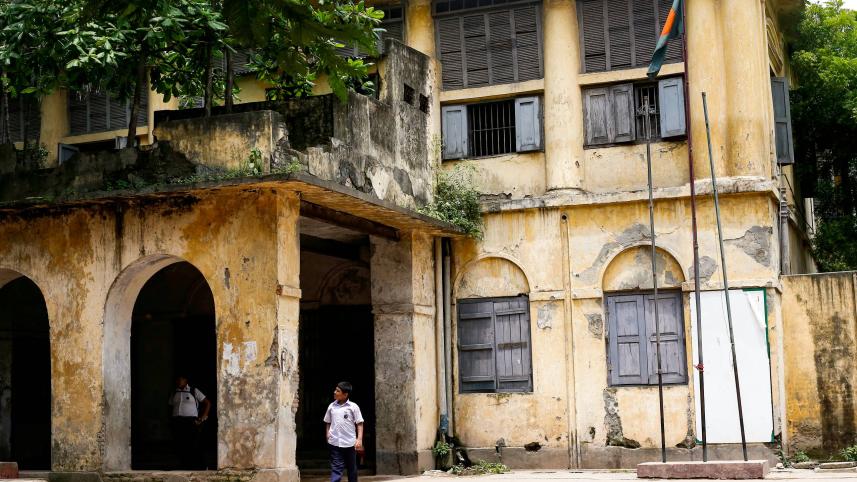 Student in front of old school building