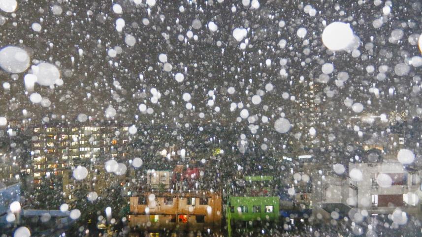 Rain on a windowpane in the dark in Dhaka