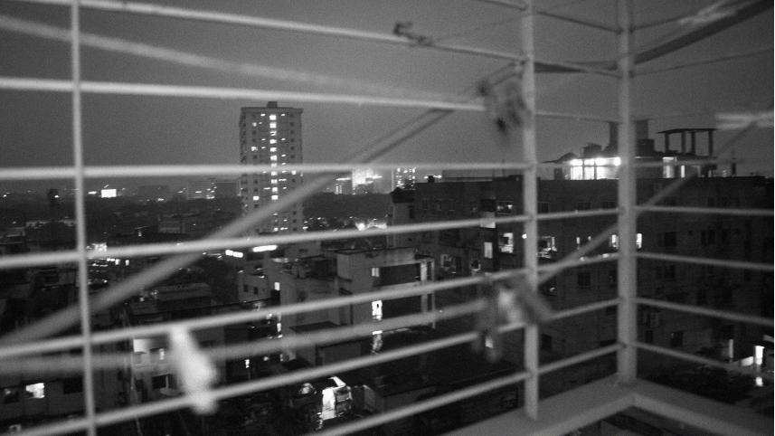 Black and white photo of view of city from a balcony