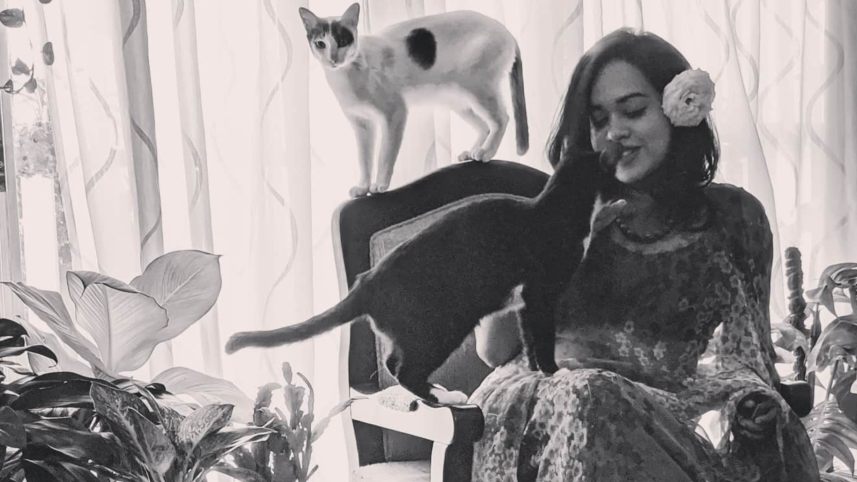 A girl with her pet cats.