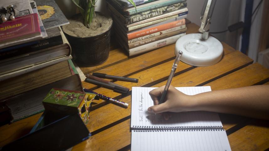 Person writing an assignment