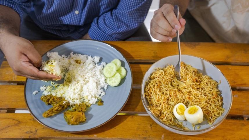 Rice and noodles on a dining table side by side eaten with hand and eaten with fork