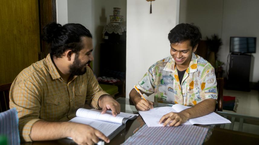Picture of a tutor teaching his student. 