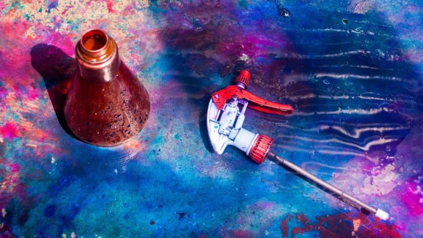 Paint splatters on and around a spray bottle