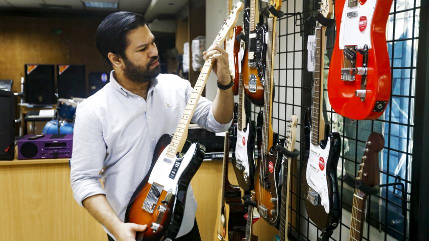 A man holding a guitar.