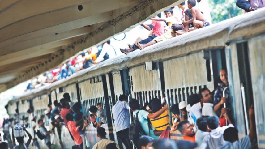 In the rush to get home for Eid, people jostle for seats at a stationary train at Kamlapur Railway Station.
