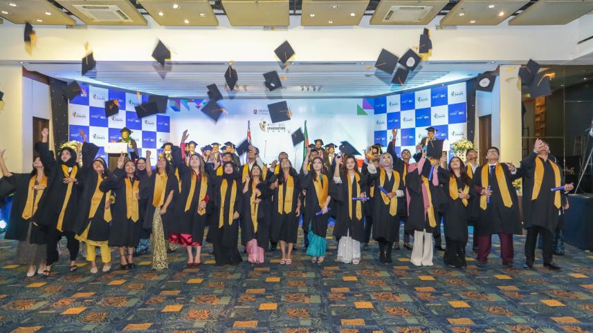 Students throwing their mortarboards up.  