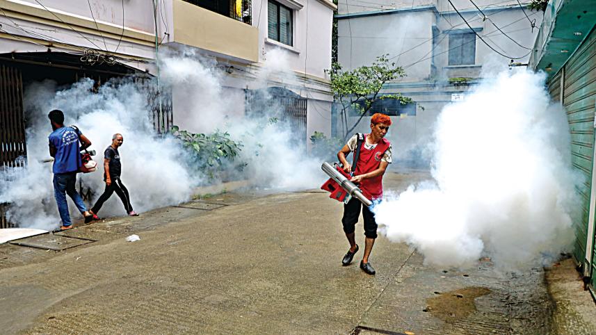 Workers of Dhaka North City Corporation using fogger machines to kill off Aedes mosquitoes in a bid to curb the spread of dengue in the capital’s Lalmatia. 