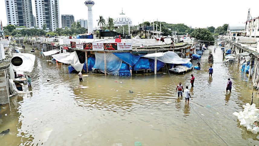 Dhaka New Market, a popular shopping destination in the city, is waterlogged around 11:00am yesterday after torrential rains on Thursday night.