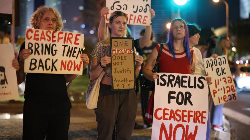 Israeli left-wing activists protest against the war and call for a ceasefire outside the Ministry of Defense in Tel Aviv.
