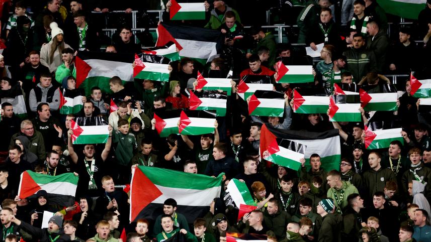 Celtic fans hold up Palestinian flags