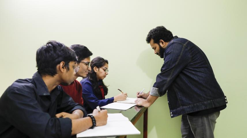 Teacher explaining a topic to his students. 