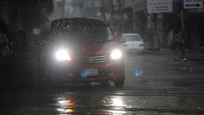 A private car is plying the road turning on head light during rain