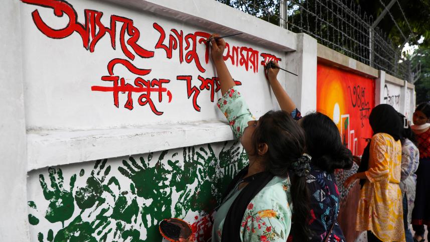 repainting vandalised walls Dhaka | Students paint over vandalised walls, give DU new life 