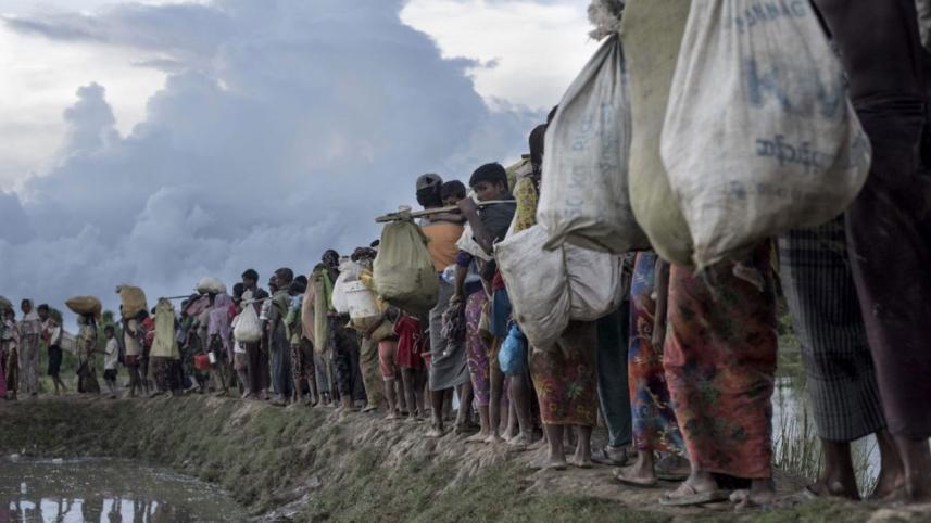 Rohingya refugees walk after crossing the Naf river from Myanmar into Bangladesh in Whaikhyang. File Photo: AFP