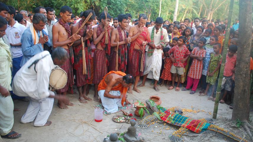 Locals perform the ritual of Charak Puja