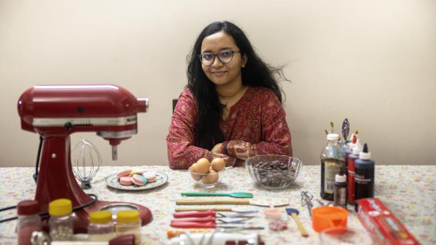 A young entrepreneur and baker with her baking utensils laid out in front of her.