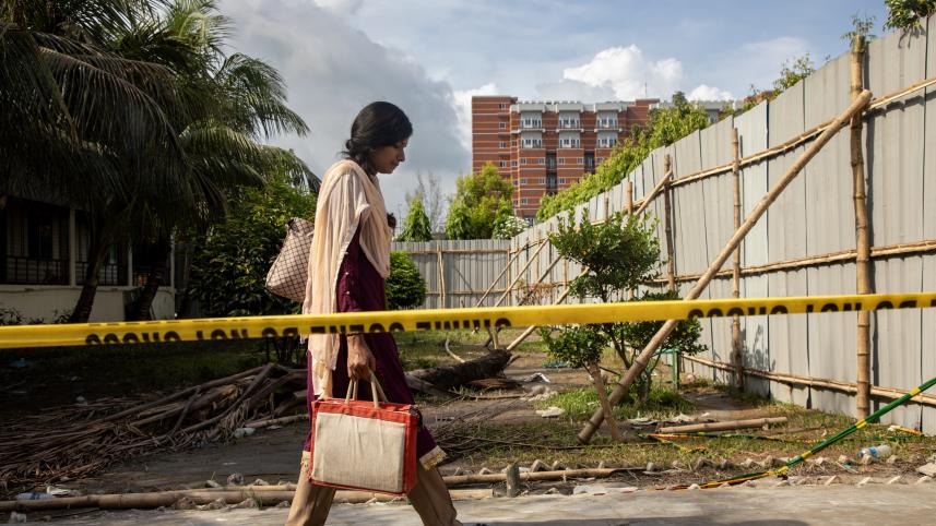 Person walking past the burn site at Milestone College 