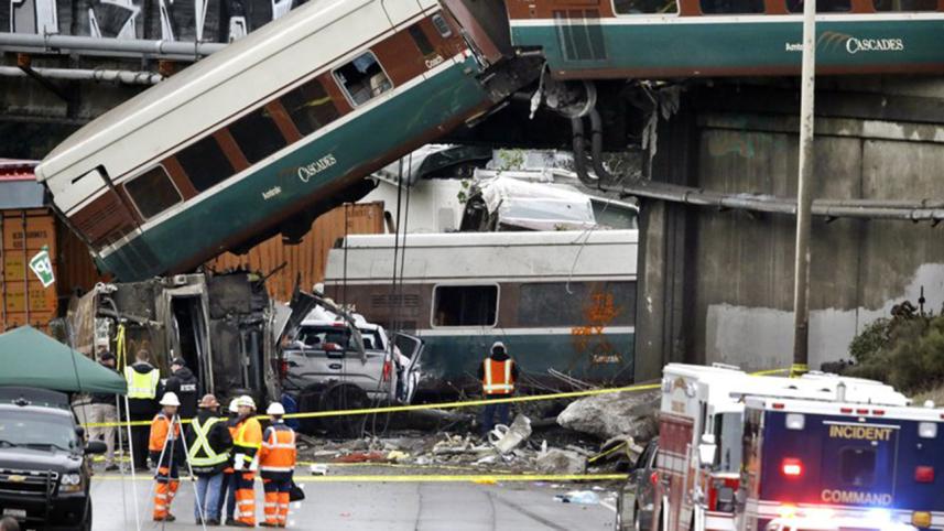 Cars from an Amtrak train lay spilled