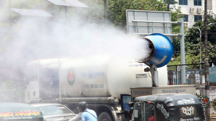 A truck-mounted cannon spraying water on vehicles on Airport Road in Banani area