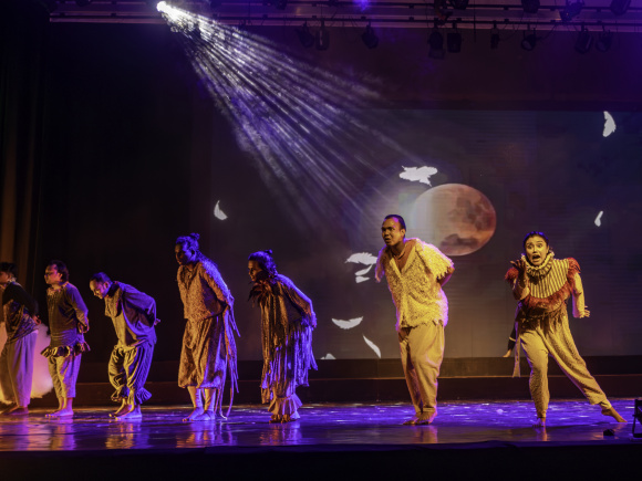 A group of performers performing on stage