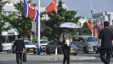The national flags of North Korea and China displayed on a street in Pyongyang as Xi Jinping visits. Photo: AFP
