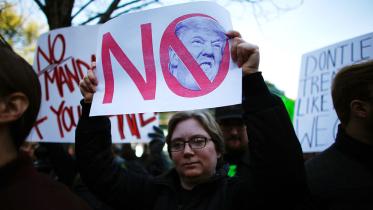 A woman holds a poster