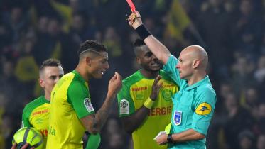 Diego Carlos and referee Tony Chapron