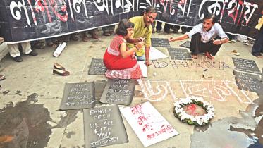 Indian social activists light candles during a protest in Kolkata on Saturday, against a fatal attack on a restaurant in the Bangladeshi capital Dhaka.
