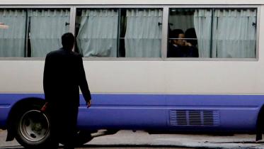 A minibus part of a Japanese convoy, as relatives of victims of an attack on the Holey Artisan Bakery and the O'Kitchen Restaurant, visited the site, in Dhaka. 