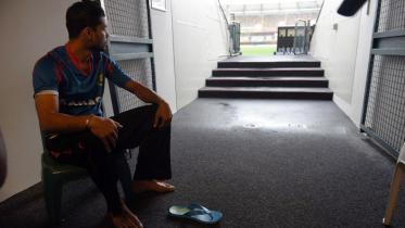 Bangladesh skipper looks at the rain while sitting idle at Gabba ground 