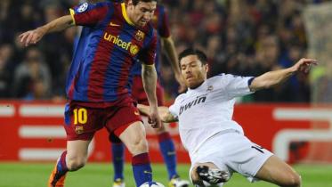 Barcelona's Lionel Messi and Real Madrid's Xabi Alonso