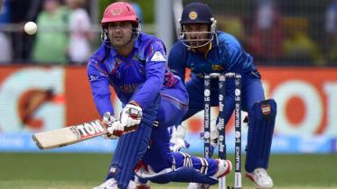 Afghanistan's captain Mohammad Nabi plays a shot 