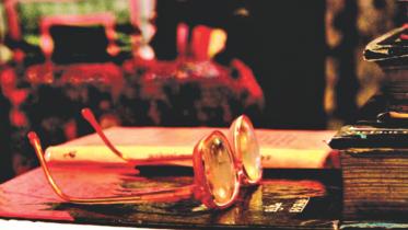Poet Sufia Kamal's spectales lie forlon on her reading table. 