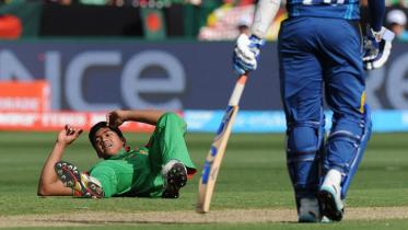 Bangladesh's Taskin Ahmed reacts after dropping a catch off his own bowling 