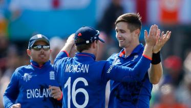 England's Chris Woakes celebrates dismissing Scotland's Freddie Coleman with team mate Eoin Morgan