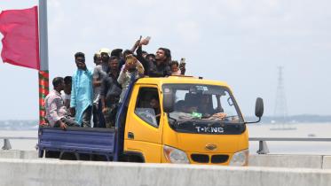People enjoying the newly inaugurated Padma Bridge on a pickup truck. 