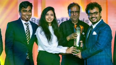 The winners being awarded the trophy 