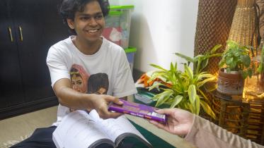 Small gesture in a family - a brother receiving chocolates from his sibling. 