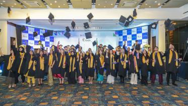 Students throwing their mortarboards up.  