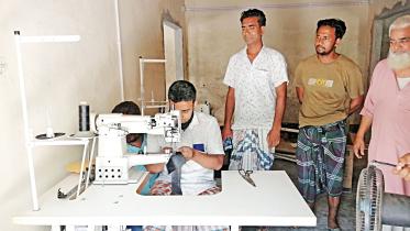 Workers are seen at the “common facility centre” established by SME Foundation for shoemakers in Kaluhati village under Rajshahi’s Charghat upazila.