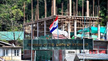 A flag of one of the Myanmar rebel forces is installed next to an under-construction structure in Myanmar's Khawmawi village on the India-Myanmar border in Mizoram