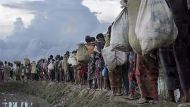 Rohingya refugees walk after crossing the Naf river from Myanmar into Bangladesh in Whaikhyang. File Photo: AFP