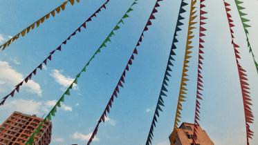 Rows of festival decoration against a cityscape